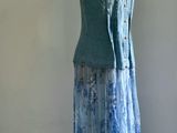 a dress on a mannequin stand in front of a wall