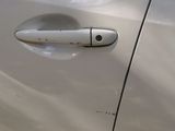 a close up of a door handle on a white car