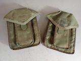 pair of old military pouchs on a white surface