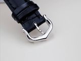 a close up of a black leather strap with a silver buckle