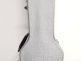 a guitar case sitting on the floor next to a wall