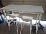 two white stools sitting at a table in a garage
