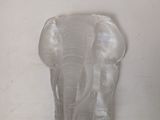 a glass elephant that is sitting on a table