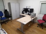 a desk with two chairs and a computer monitor on it