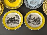 yellow and black plates with a picture of a man and a woman on them