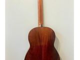 an acoustic guitar hanging on a wall in a room