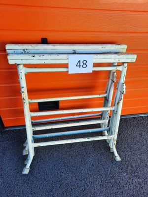 a white metal rack with a number 48 on it in front of an orange wall