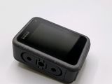 a small black cell phone sitting on a white table