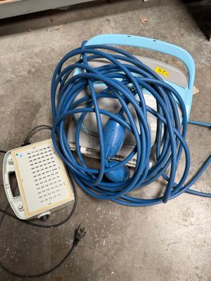 a blue hose that is connected to an electrical device