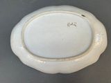 a white plate with a gold rim sitting on a table