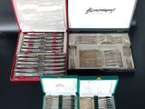 a lot of silverware in a case on a table