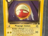 a pokemon card in a plastic case on a table