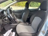 the interior of a small car with a steering wheel and a dashboard