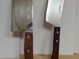 two knives that are sitting on a wooden table