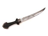a knife that is sitting on a white surface