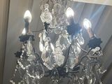 a crystal chandelier hanging from the ceiling in a room