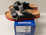 a pair of sandals that are on top of a box