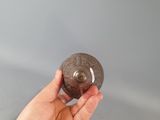 a person holding a rock in their hand on a table