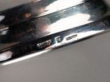 a close up of a silver plate on a table