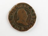 une vieille pièce de monnaie avec un visage d'homme dessus