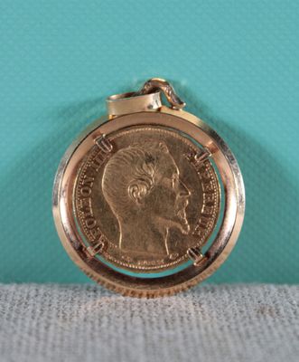 an image of a gold pocket watch with a coin on it