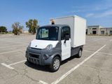 a small white box truck parked in a parking lot