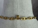 a close up of a mannequin torso with a gold chain on it