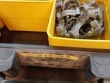 yellow bins filled with assorted bolts and nuts on top of a table