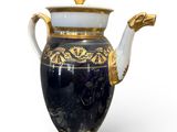 a black and gold vase with a gold handle