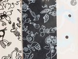 a black and white picture of a skateboard with a pattern on it