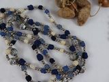 a necklace with beads and beads on a table