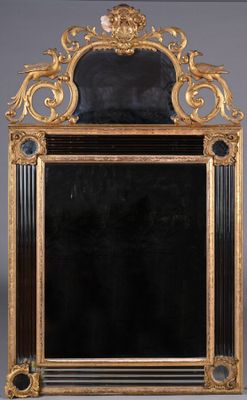 an ornate gold framed mirror with a lion head on top of it