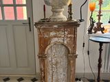a bust of a man on a pedestal in a room