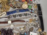 many different types of bracelets and rings on the table