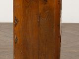 an old wooden chest of drawers sitting on top of a hard wood floor