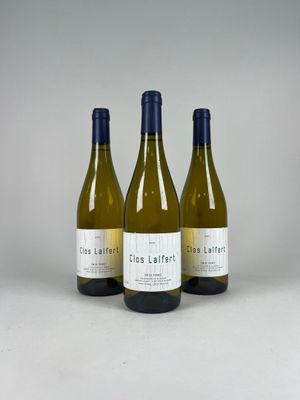 three bottles of white wine sitting next to each other on a table