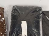 three pieces of clothing are wrapped in plastic bags on a white surface