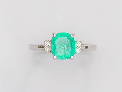 an oval emerald and diamond ring