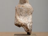 statue of a woman sitting on a block on a table