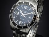 a close up of a watch on a black surface