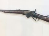 an old gun on a wall with a white background