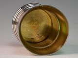 a close up view of a glass with a yellow liquid inside of it