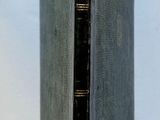 a black book that is sitting on a white table