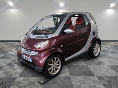 a small car that is sitting on a checkered floor