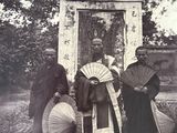 a group of people that are standing in front of a clock