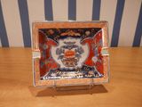 a plate with a dragon on it sitting on a table