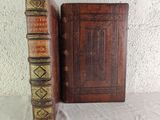 two old books sitting on a table next to each other
