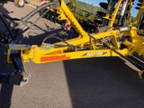 a yellow machine that is parked on the side of the road