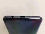 the back of a black phone with a purple back and a blue back