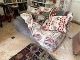 a couch that has many pillows on it in the living room